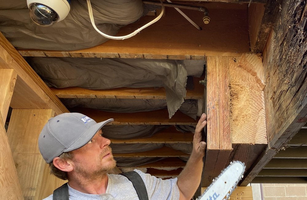Steven Watson inspecting structural framing